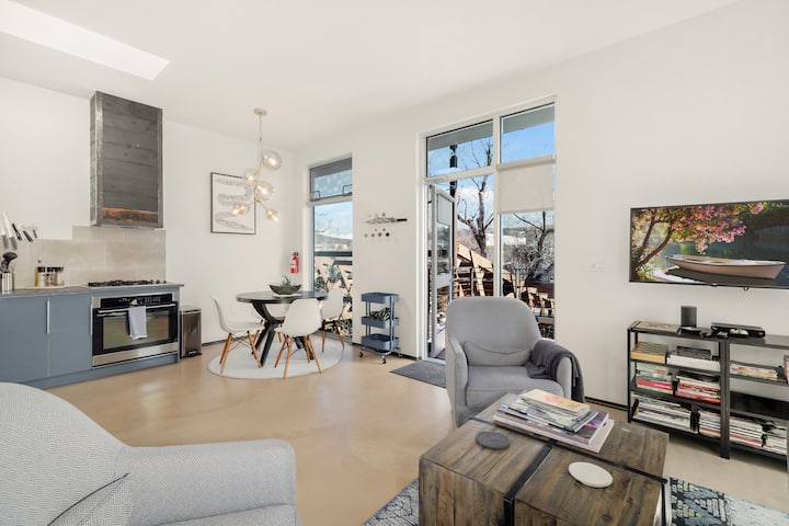 Airy Santa Fe rental with skylight, gray cabinets, and French doors opening to a patio